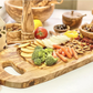 olive wood charcuterie board on a table with vegetables , crackers, nuts,  crackers and cheese