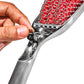Close-up of a hand holding a metal grater with red interior