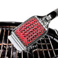 Red grill brush with a metal handle on a grill