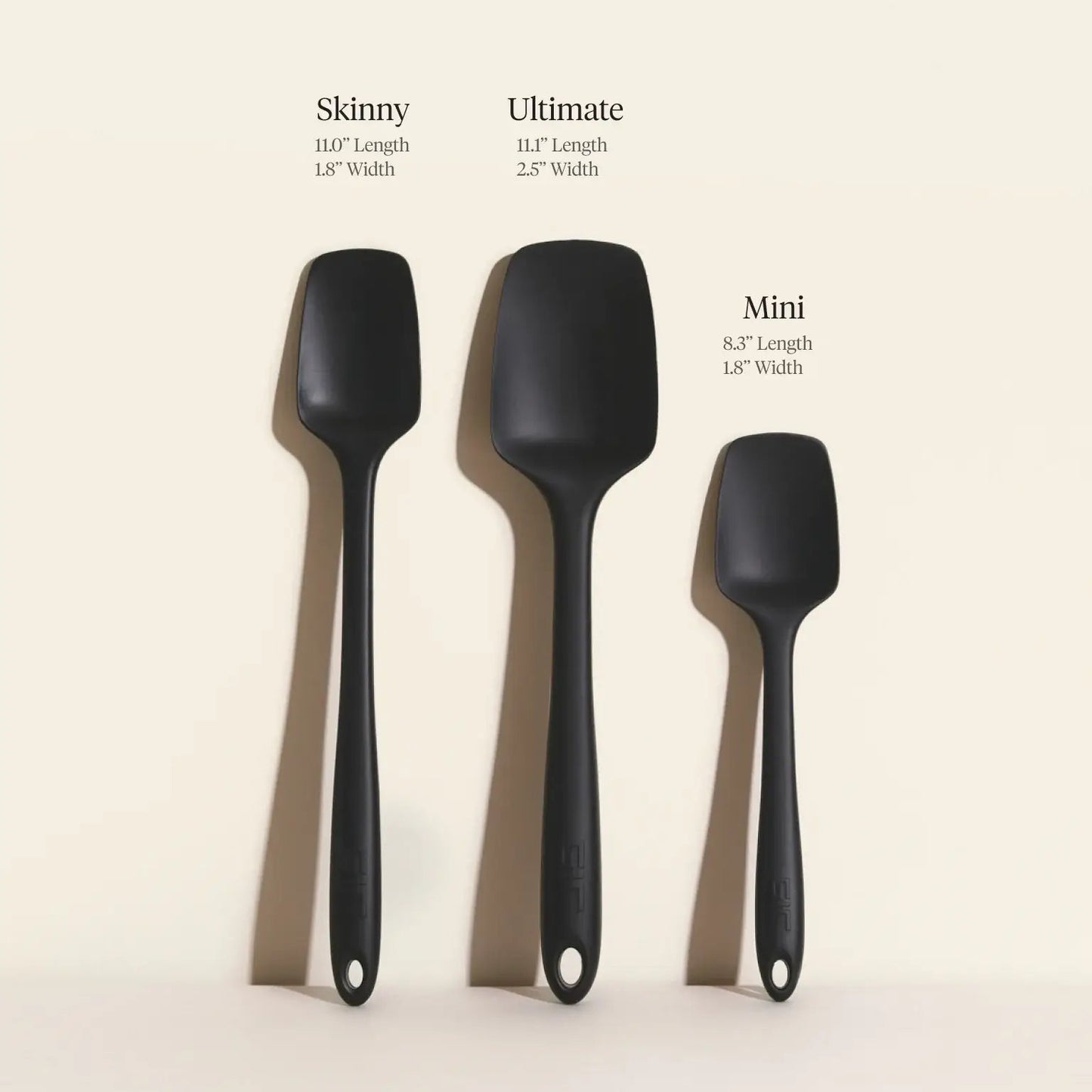 Three black spatulas labeled 'Skinny', 'Ultimate', and 'Mini' on a beige background.