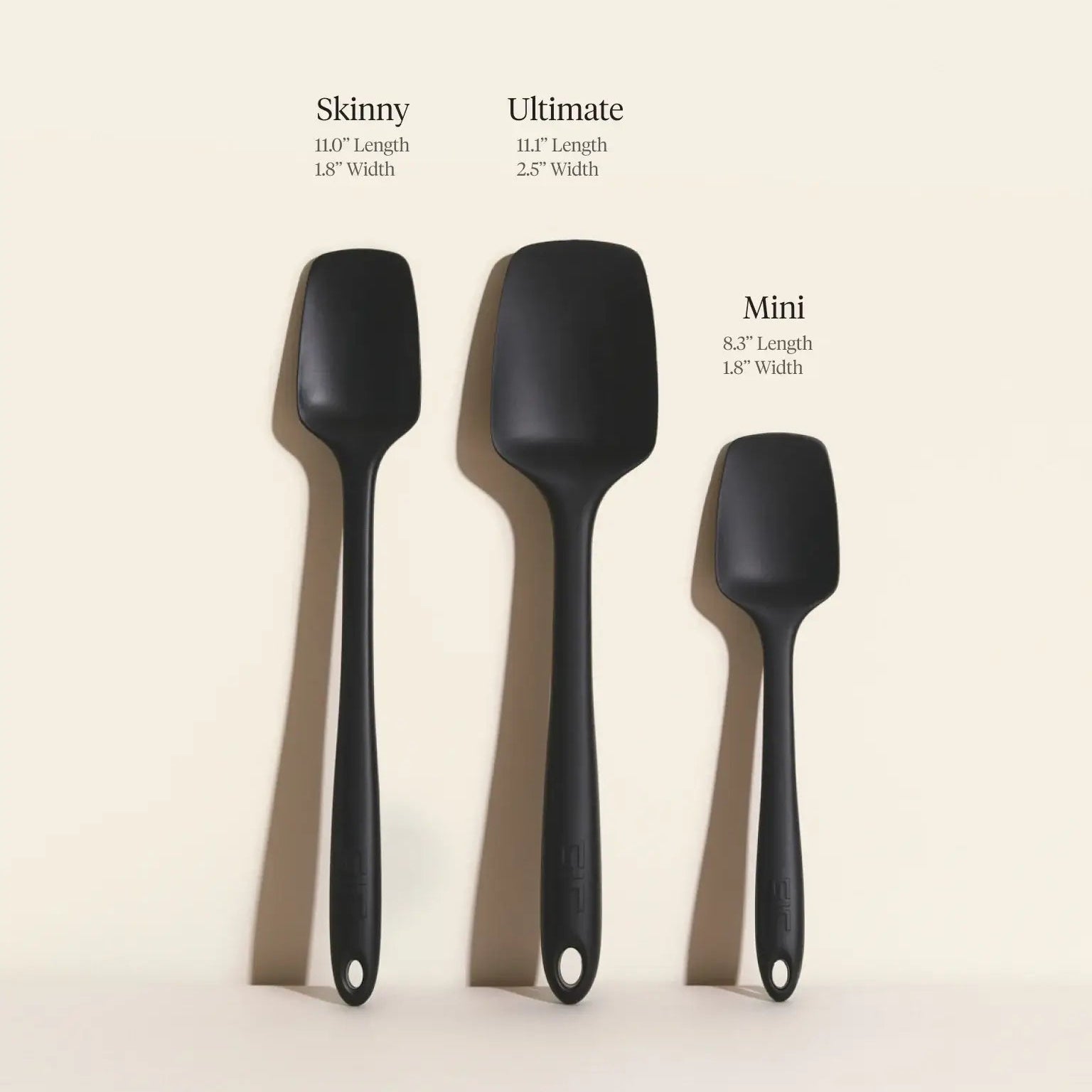 Three black spatulas labeled 'Skinny', 'Ultimate', and 'Mini' on a beige background.