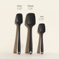 Three black spatulas labeled 'Skinny', 'Ultimate', and 'Mini' on a beige background.