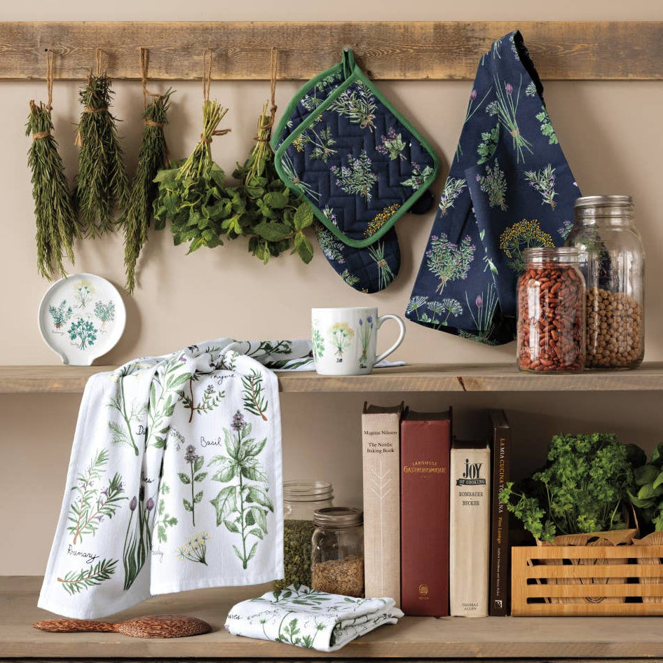 Kitchen shelf with herbs, towels, and books against a beige wall.