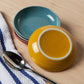 Add a pop of color to your table with the Canyon Dipping Dishes, a set of four stackable stoneware bowls in bold yellow, blue, grey, and red hues. Perfect for serving dips, nuts, candies, and more, these versatile dishes are both stylish and functional. 