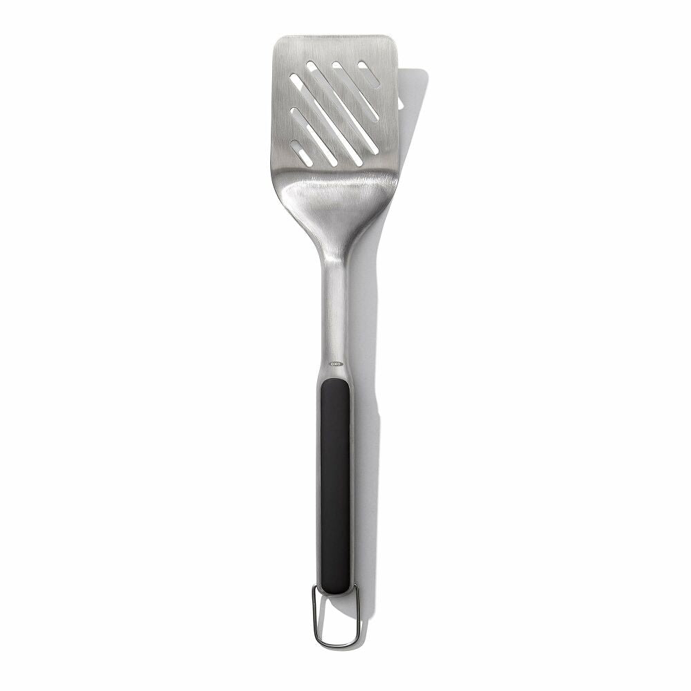 Metallic spatula with a black handle on a white background