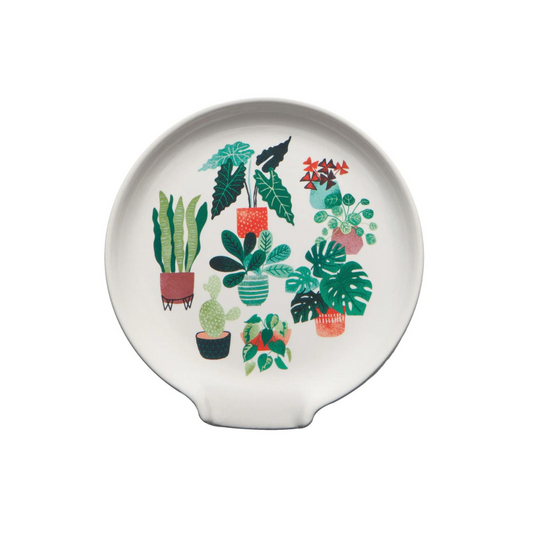 Stoneware spoon rest for the stove top in a neutral white color with beautiful green various houseplants as the pattern.  Dishwasher safe so you can always have a clean green spoon rest!