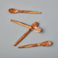 olive wood mini scoop spoon set of 4 on a counter