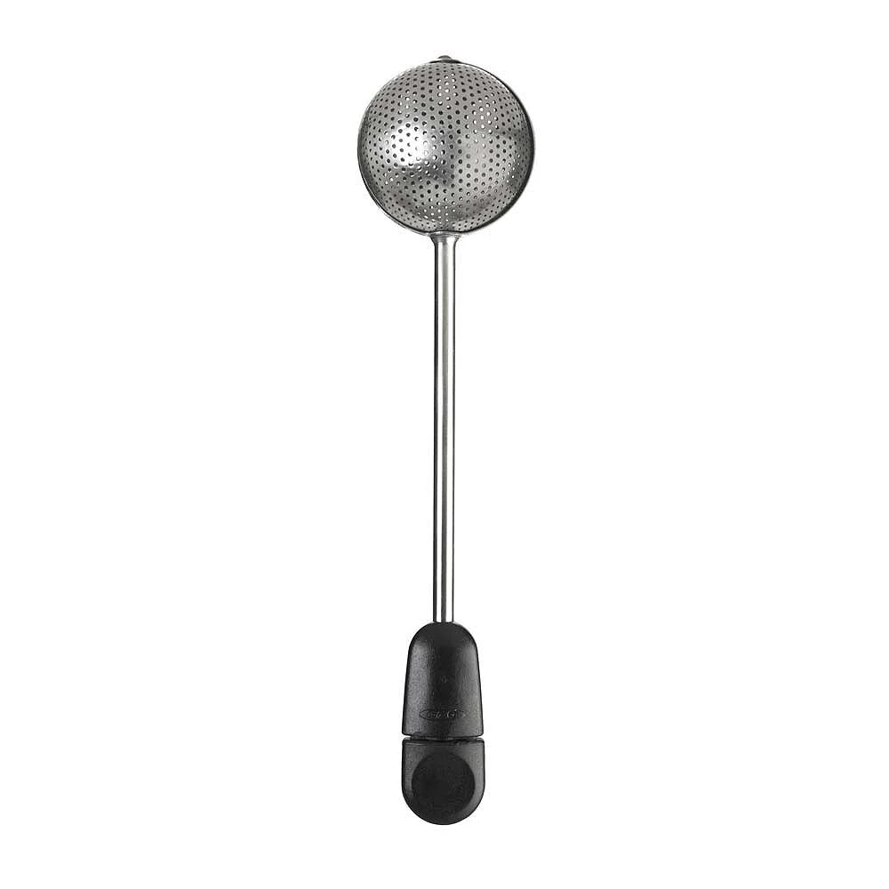 Metallic tea ball with black handle on a white background