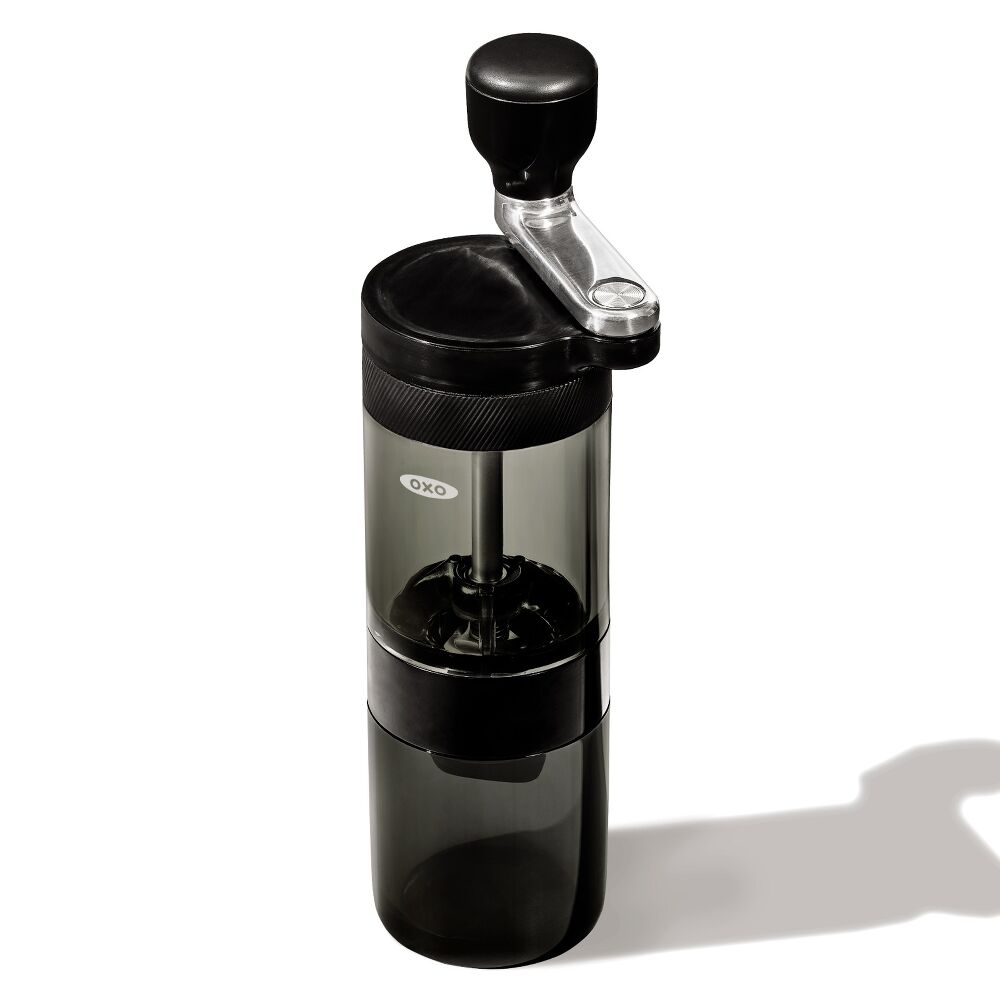 Black manual coffee grinder on a white background
