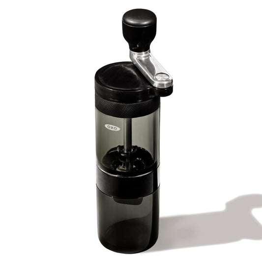 Black manual coffee grinder on a white background