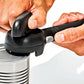 Hand using a can opener on a can against a white background