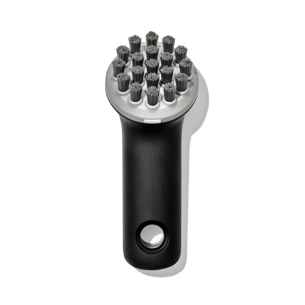 Black and silver grill brush on a white background