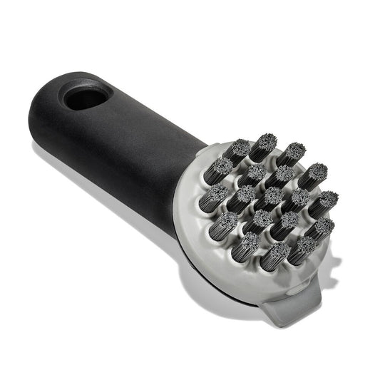 grill brush with black handle on a white background