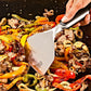 Frying pan with stir-fried vegetables and meat being stirred with a spatula.
