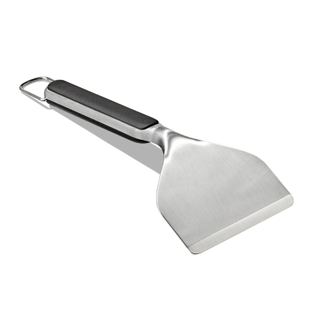 Metal spatula with a black handle on a white background