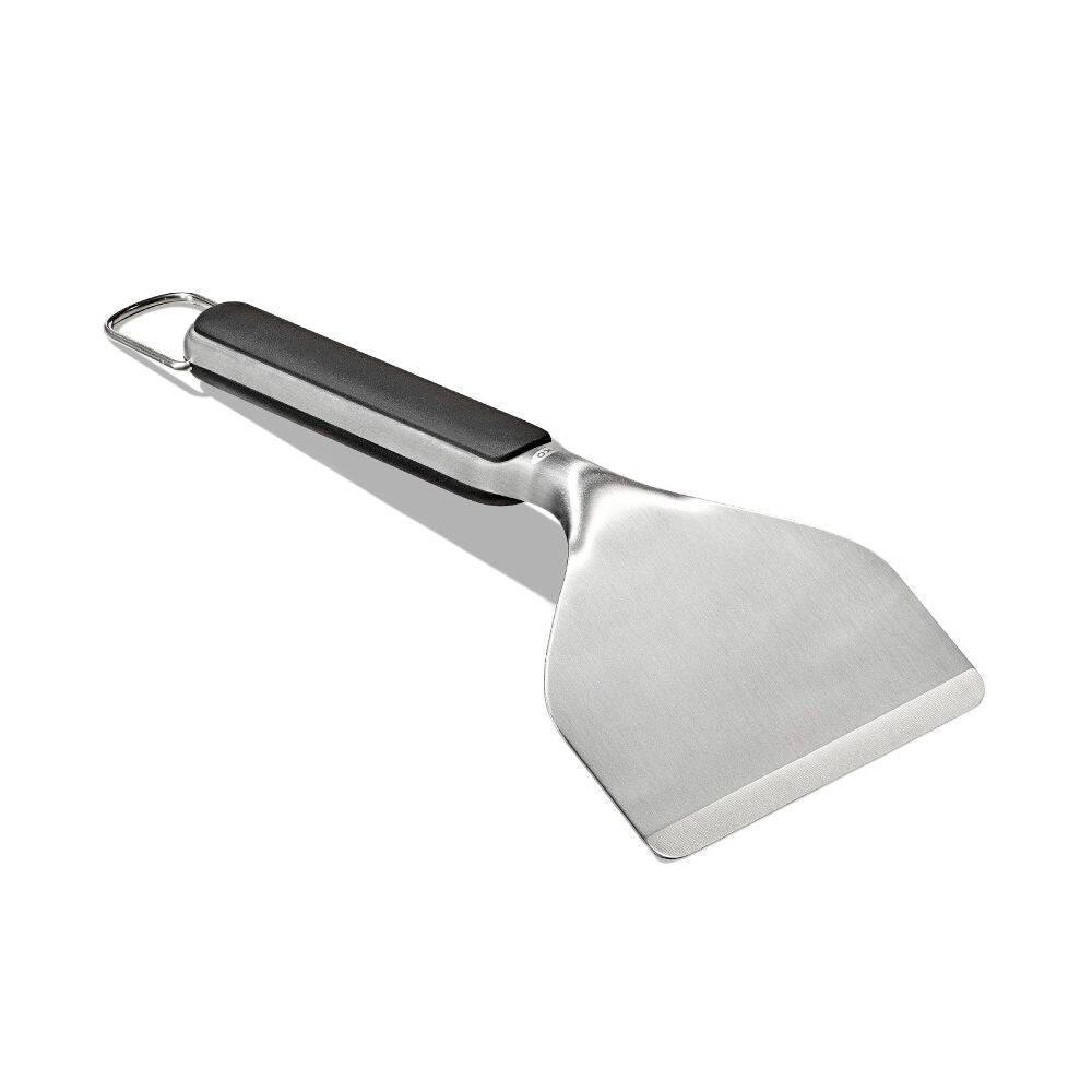 Metal spatula with a black handle on a white background