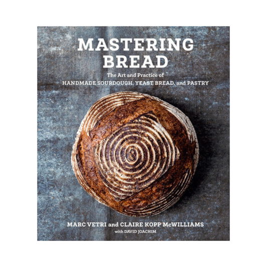 Book cover of 'Mastering Bread' with a loaf of bread on a textured background