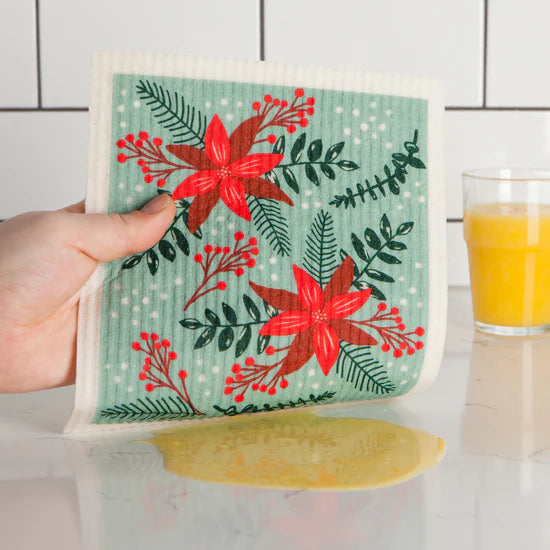 Embrace the classic Christmas spirit with the Poinsettia Swedish Sponge Cloth by Ecologie! Decked out in vibrant red poinsettias, this festive dishcloth adds a burst of holiday cheer to every clean-up task. 