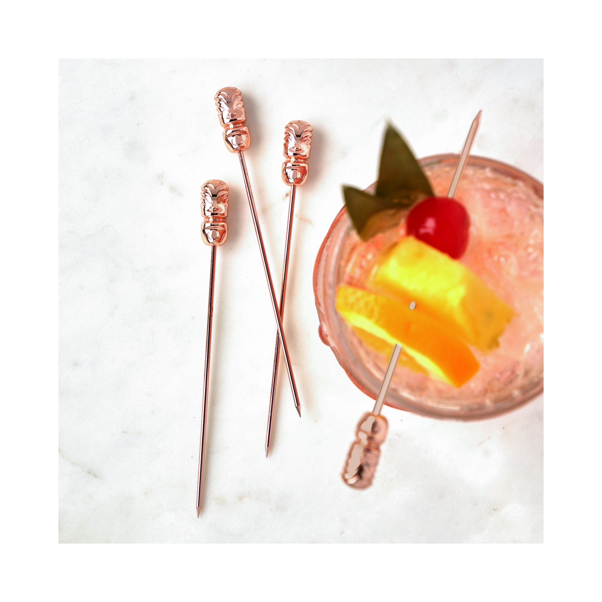 Elevate your mixology game with our Set of 4 Rose Gold Tiki Cocktail Picks, the perfect blend of style and function for any cocktail enthusiast. Crafted from premium stainless steel and adorned with a chic rose gold finish, these picks add a touch of glamour to your drink presentation. The Tiki-inspired design not only serves as a trendy aesthetic but also ensures a secure grip on garnishes, making them ideal for both casual gatherings and upscale soirées. 