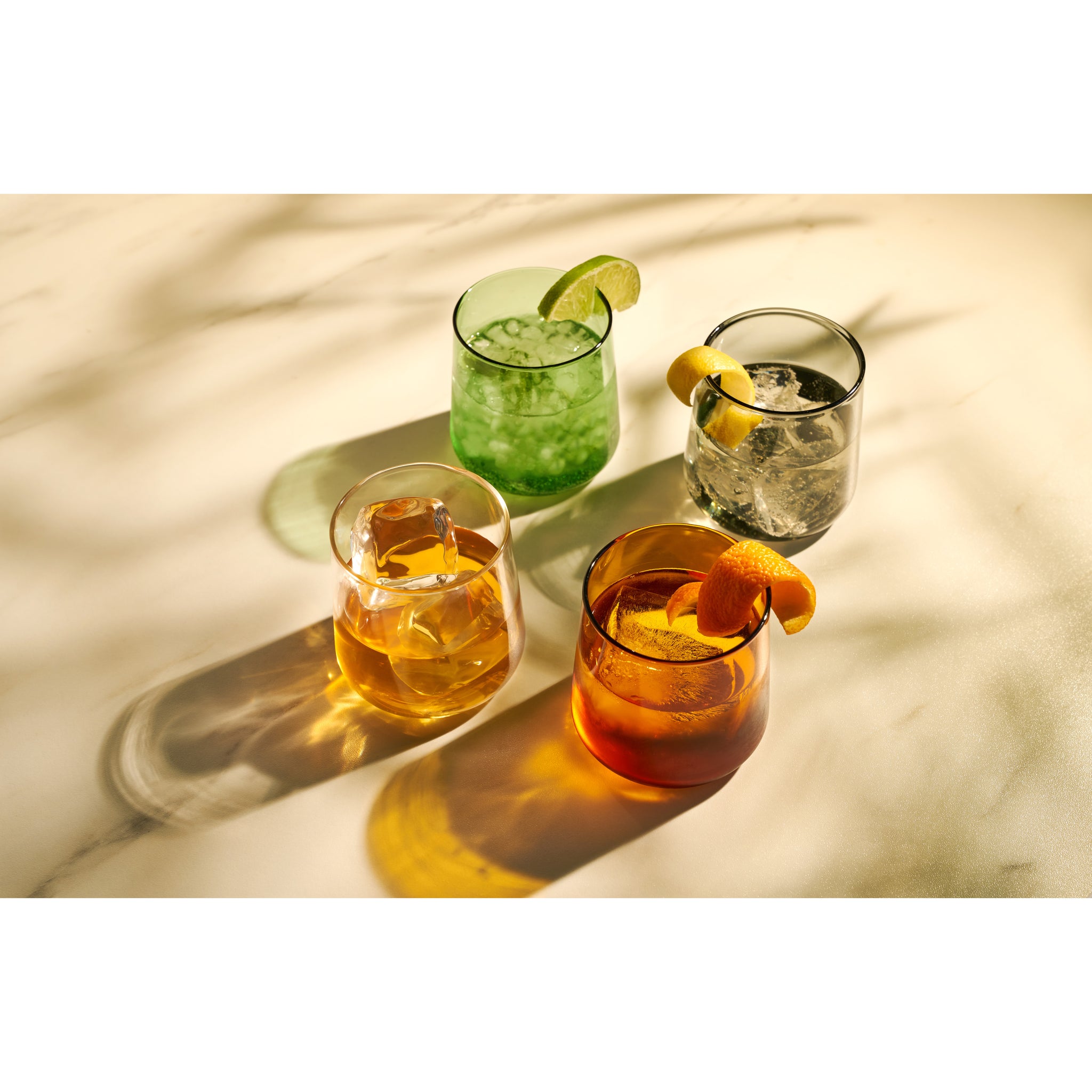 Handcrafted from durable glass with natural minerals, this bright 4-piece set is perfect for cocktails, wine, or iced coffee. Each glass holds 10.5 oz. and is dishwasher safe. Sturdy borosilicate glass ensures high quality and lasting use. The modern design features unique, vintage hues that fit any décor style.