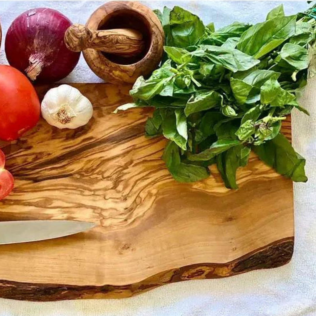 olive wood rustic cutting board with vegetables on counter