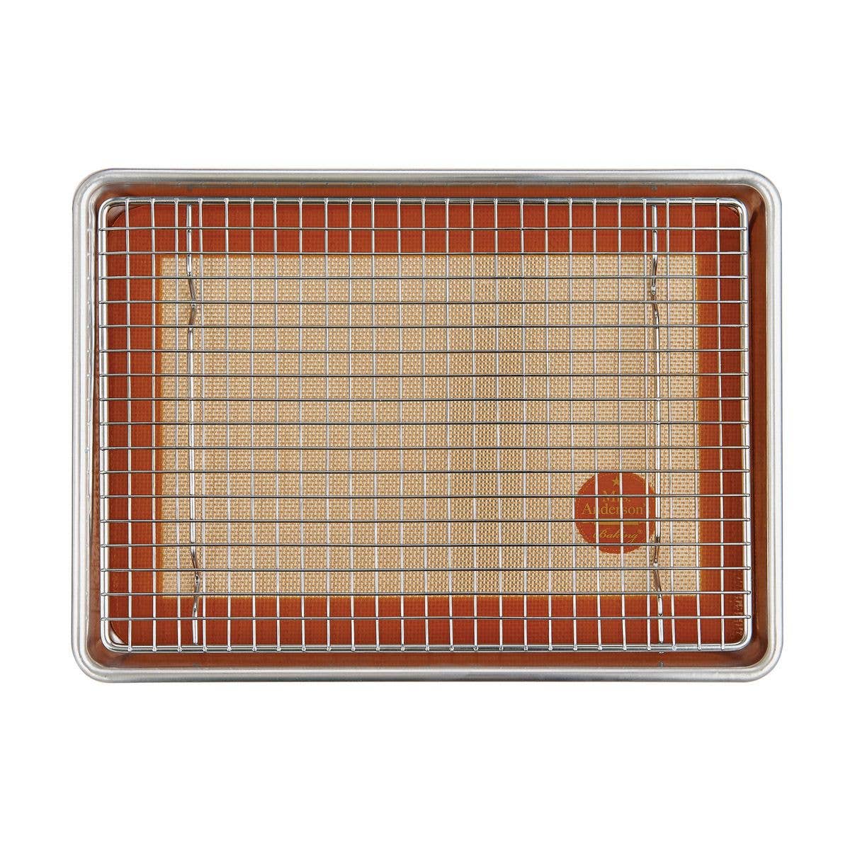 Baking tray with wire rack and silicone mat on a white background