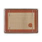 Baking tray with wire rack and silicone mat on a white background