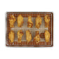 Fried chicken wings on a wire rack over a baking sheet with a white background