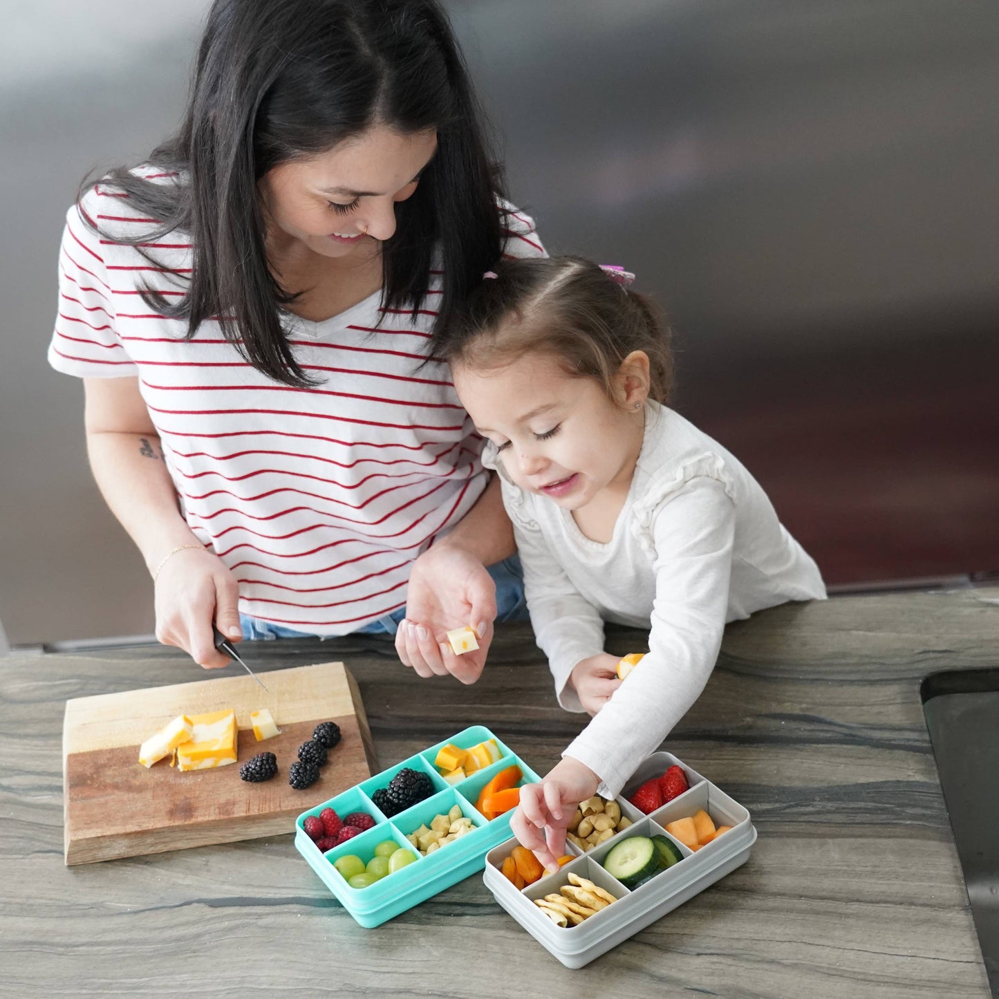 Woman and child preparing food in a kitchen setting