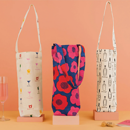 Gift a bottle of wine in the vibrant, floral beauty of the Happy Hour Poppy wine bag! Bursting with bold reds, petal pinks, and refreshing blues, this eye-catching design adds a pop of color and charm to any occasion. Perfect for impressing even the most discerning wine lovers, it’s the ideal way to celebrate with style and a touch of floral fun. Cheers to a beautiful gift!